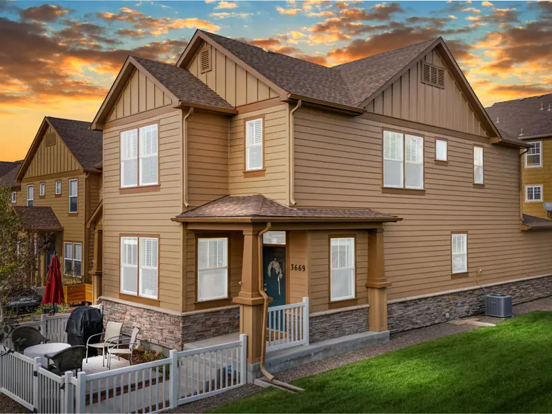 Craftsman home with stone accents at dusk