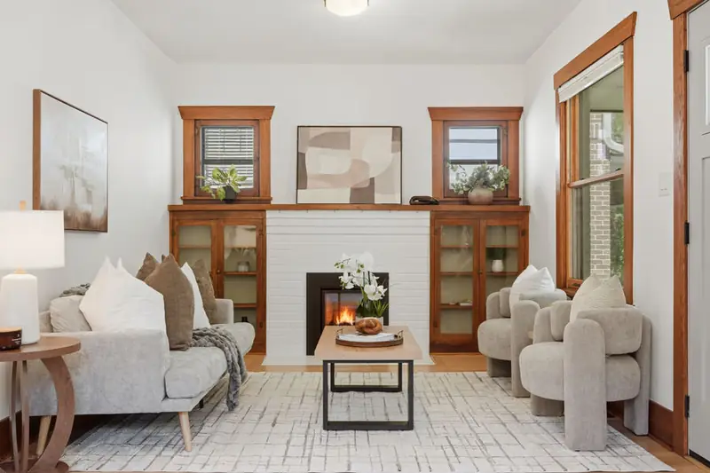 Staged living room with a white fireplace