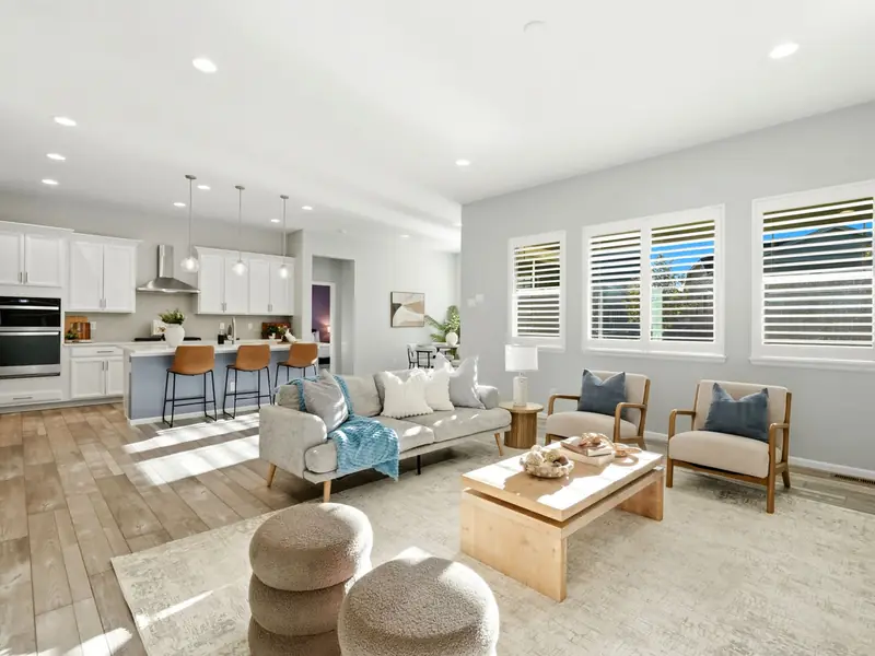 Staged great room with kitchen and shutters